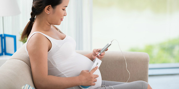 pregnant asian woman using pregnancy technology