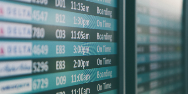 airport departure board symbolizing overseas insurance requirements for staff of thai companies