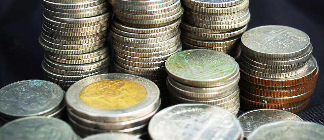 Stacked coins to showcase IPMI premiums in Thailand and inflation