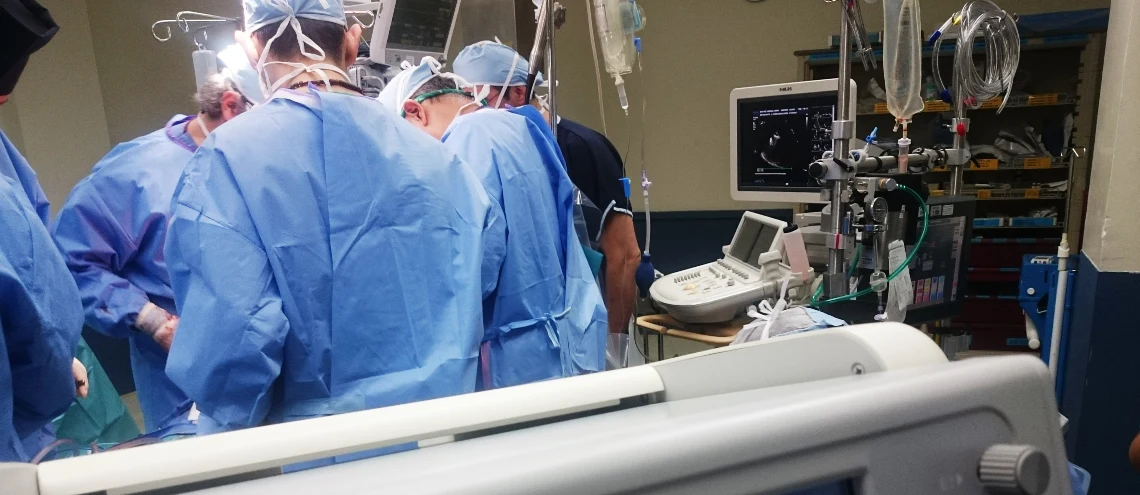 A group of surgeons performing surgery in an operating room