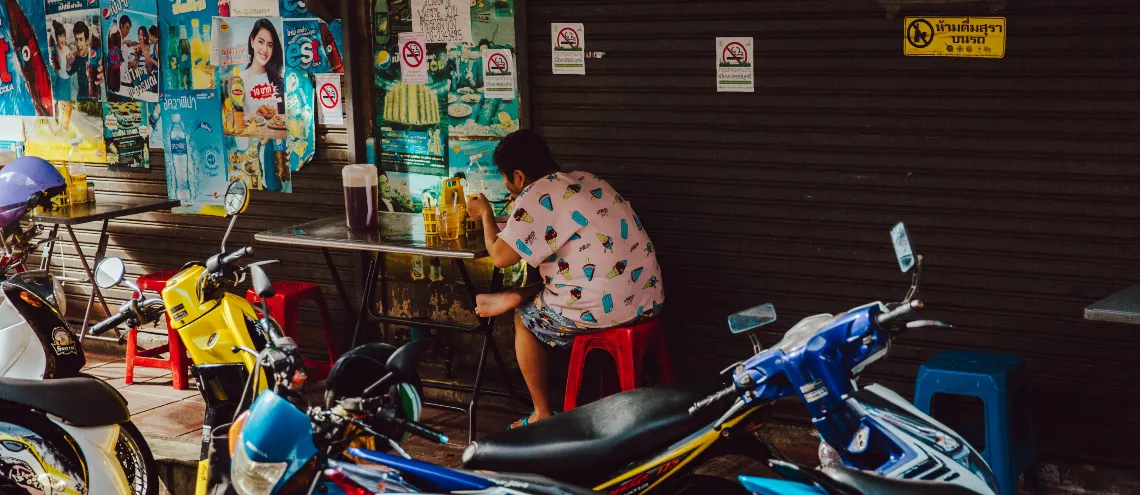 A person having a meal at a restaurant on the roadside