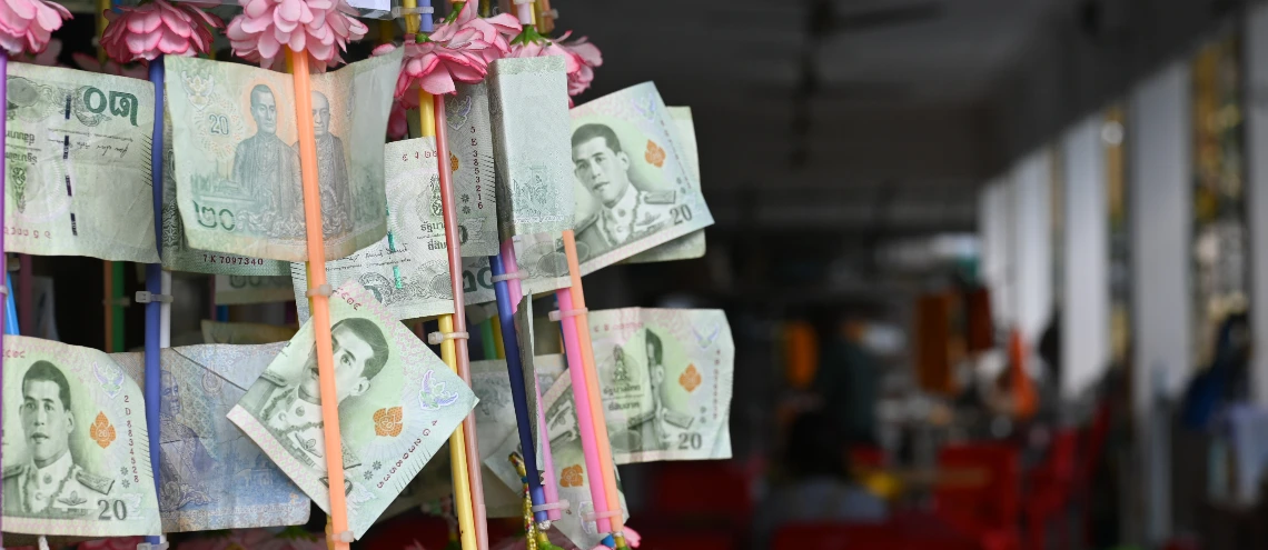 Thai banknotes tied together in rows