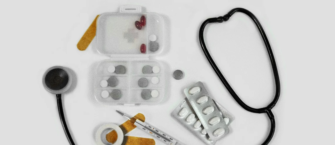 Medical equipment and medicine on a white desk