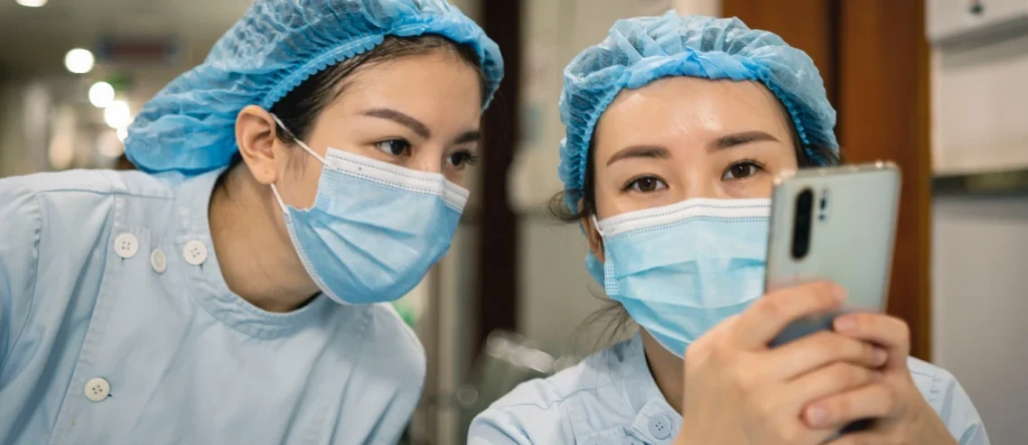 Two Asian nurses wearing protective medical gear