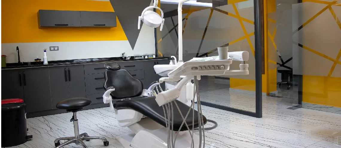 Empty dental treatment room with equipment and chair