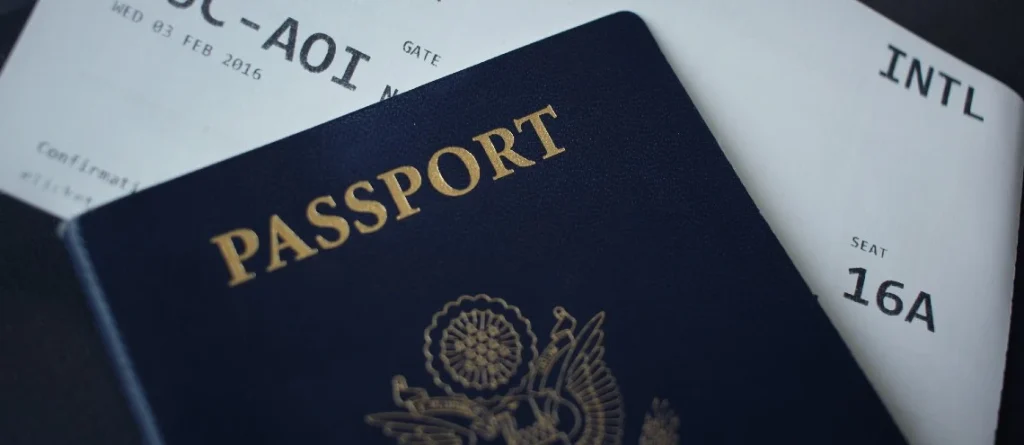 Image shows a passport and boarding pass.