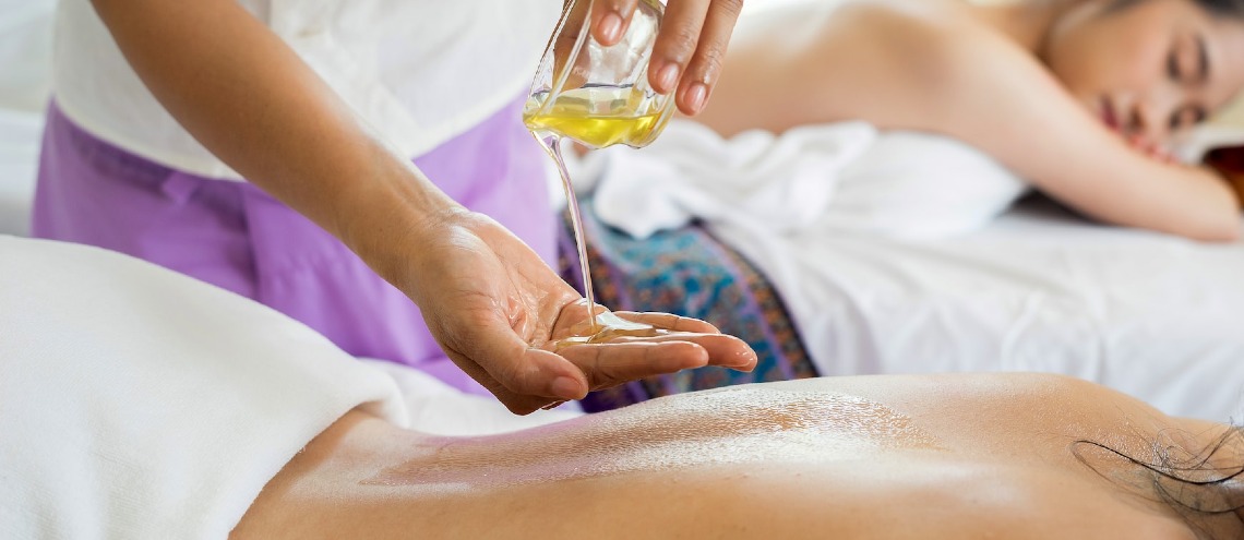 Thai massage with scented essential oil offered at wellness retreats for expats. 