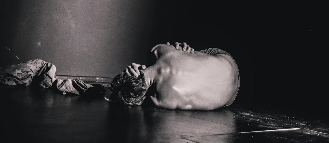 A man laying on the floor in agony