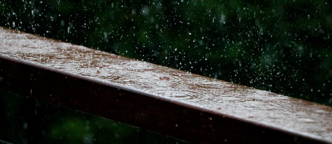 Rain falling on a wooden fence