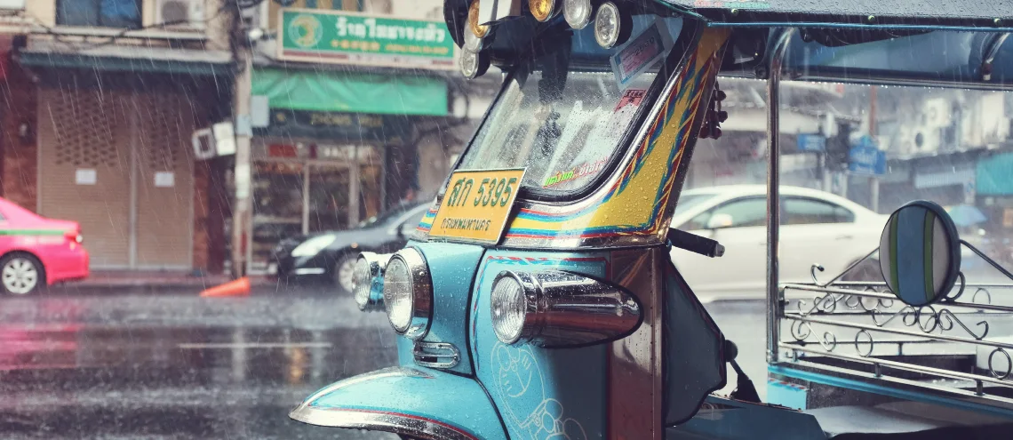 Tuktuk parking on a raining road