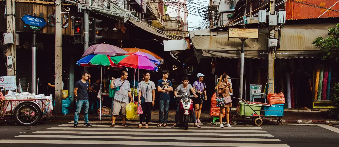 People waiting to cross the road in Thailand