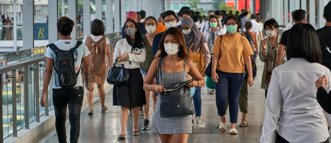 People wearing masks walking on BTS skywalk