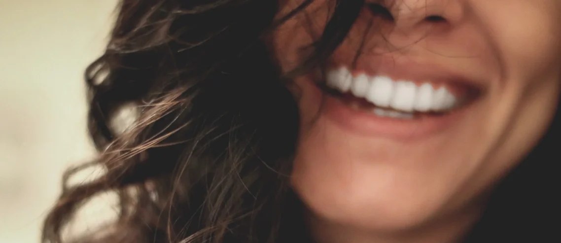 Close up of woman smiling with straight white teeth dental care