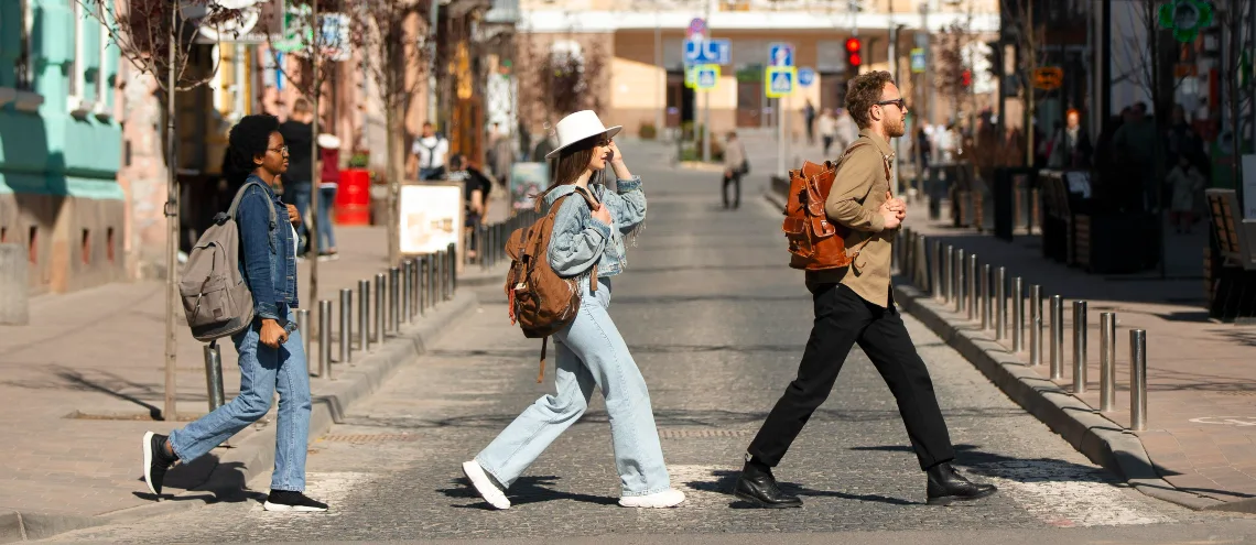 Three people crossing a street in France